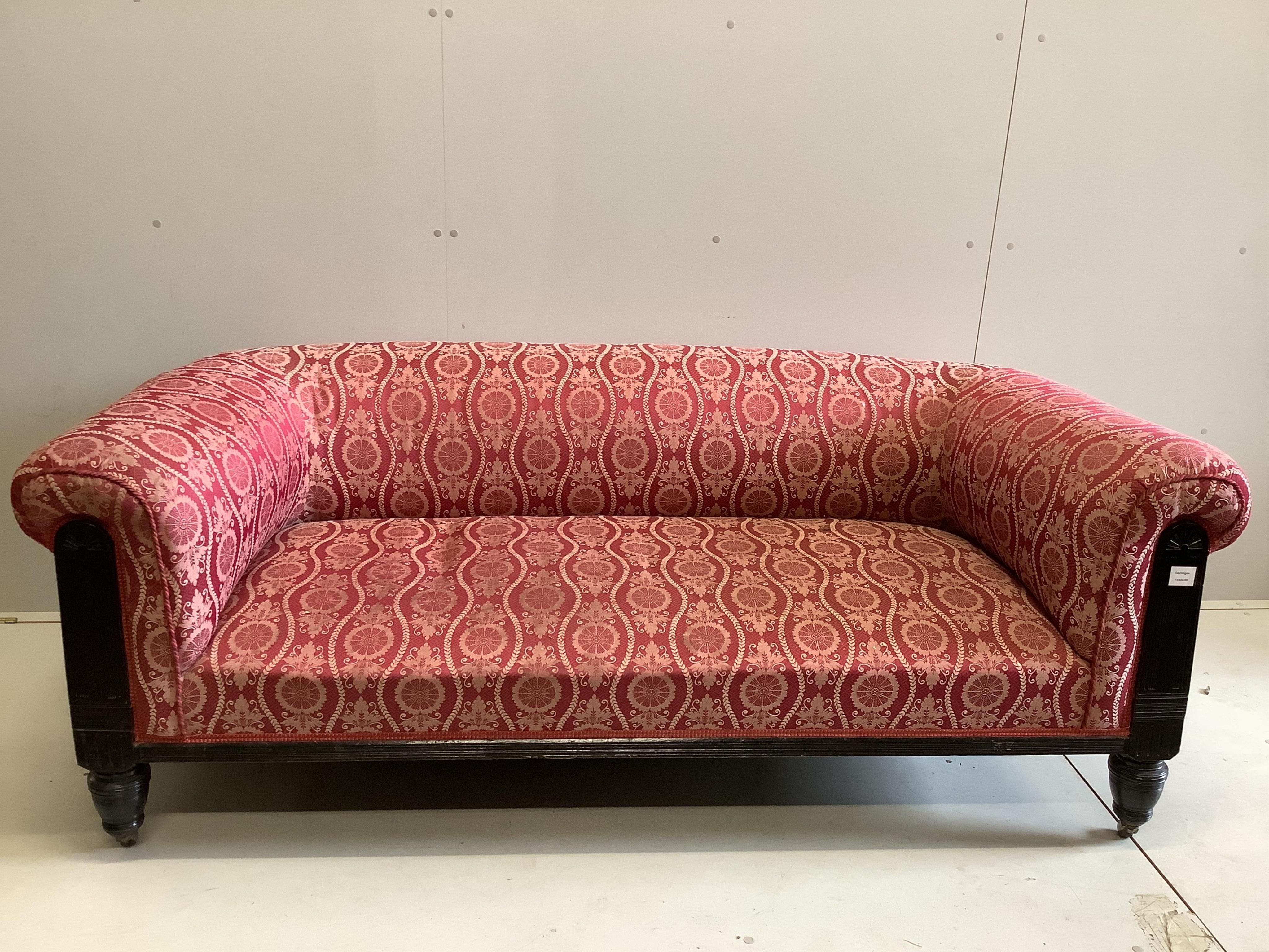 A late Victorian ebonised upholstered settee, the red and cream brocade fabric over horse hair upholstery, width 180cm, depth 88cm, height 70cm. Condition - good
